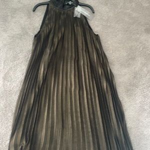 This is a fabulous pleated dress. It has a small peephole in the back.